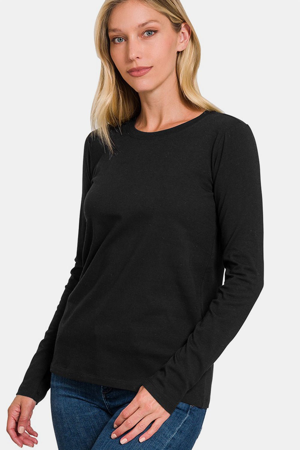 Woman wearing a black full-size round neck long sleeve T-shirt made of cotton and spandex, casual style.
