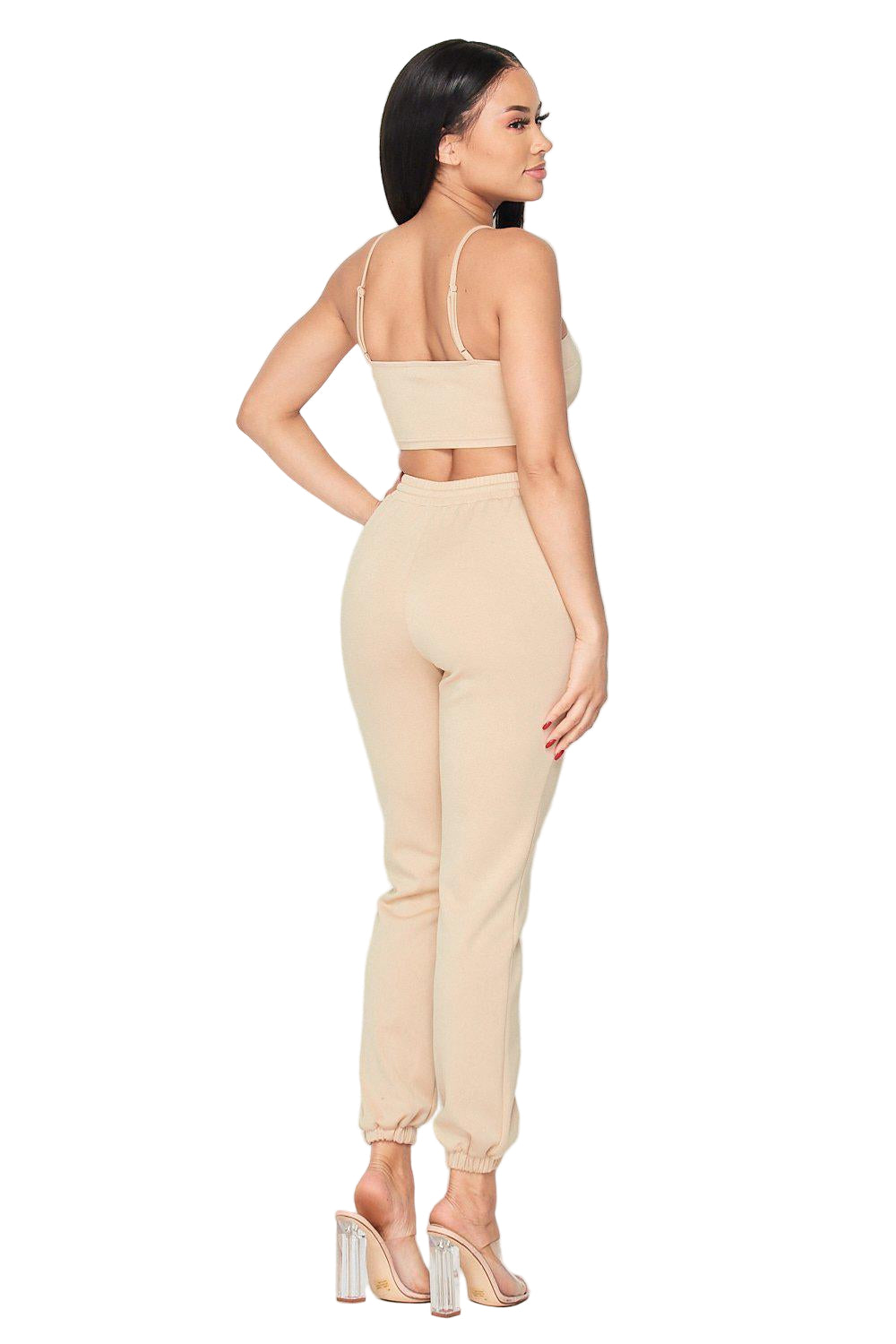 Woman wearing Keep It Cute Two-Piece Set in beige, showing back view, featuring a crop top and joggers, stylish and comfortable outfit.