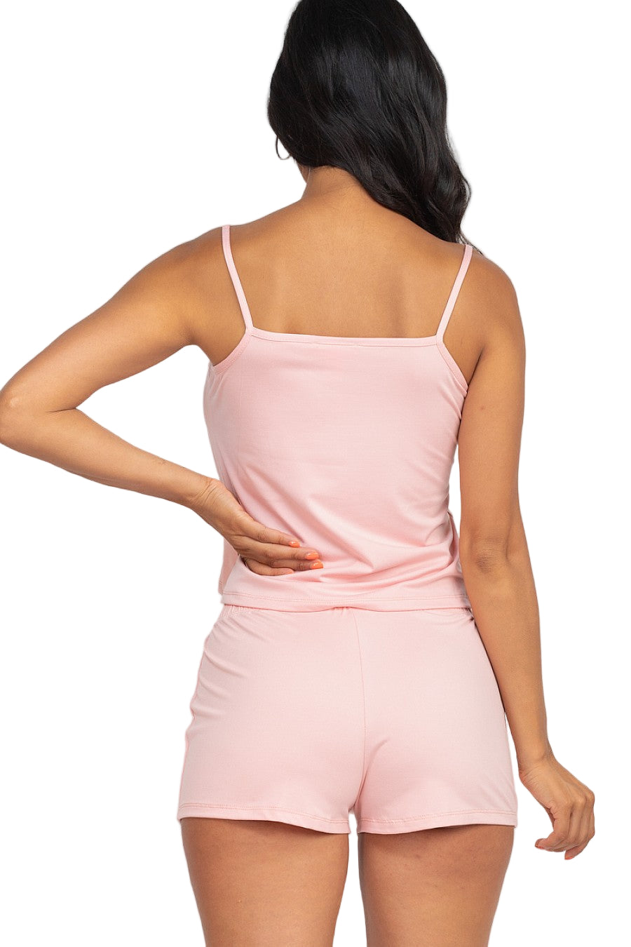 Woman in pink cami top and shorts set made from high stretch jersey fabric, showcasing comfortable, skin-friendly, sleeveless design.