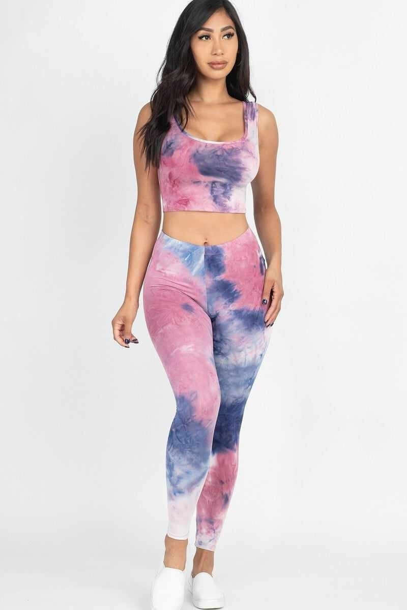 Woman in tie-dye activewear set confidently showcasing trendy and functional style for active lifestyles.