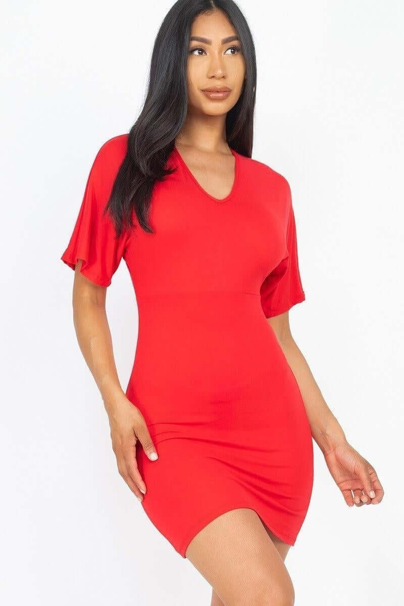 Woman wearing a bold red dress with short sleeves, perfect for any occasion and personal style.