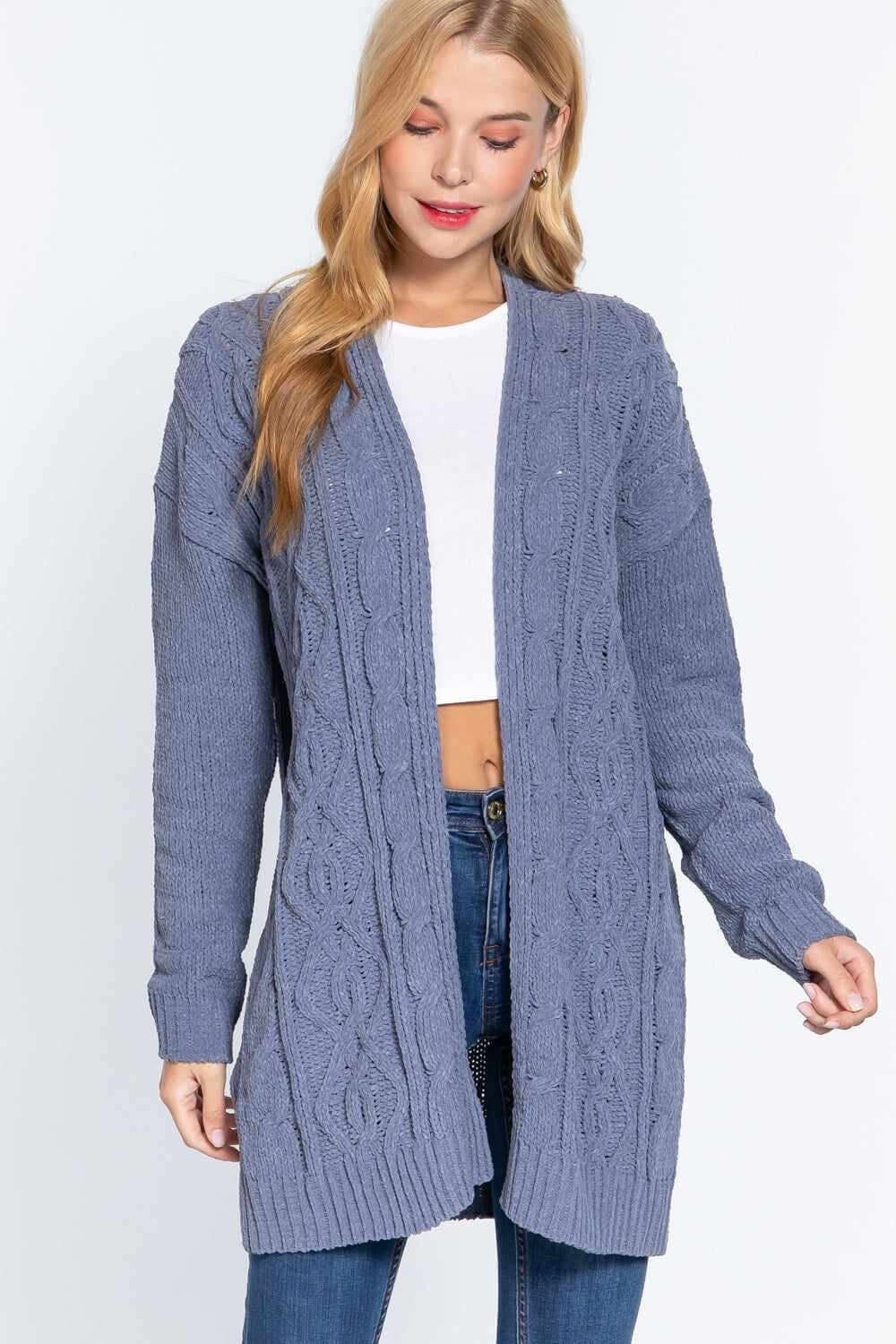 Woman wearing cozy blue cable-knit cardigan over white top and jeans, from our Women's Cozy Sweaters & Cardigans collection.