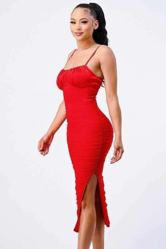 Woman wearing a red curve-hugging bodycon dress with a side slit, showcasing a confident and feminine style.