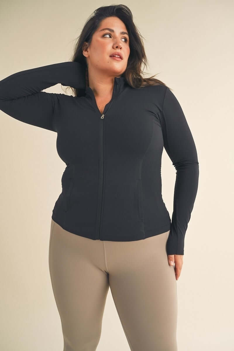 Plus size woman wearing stylish and comfortable black activewear top from Curvy Active Wear collection.