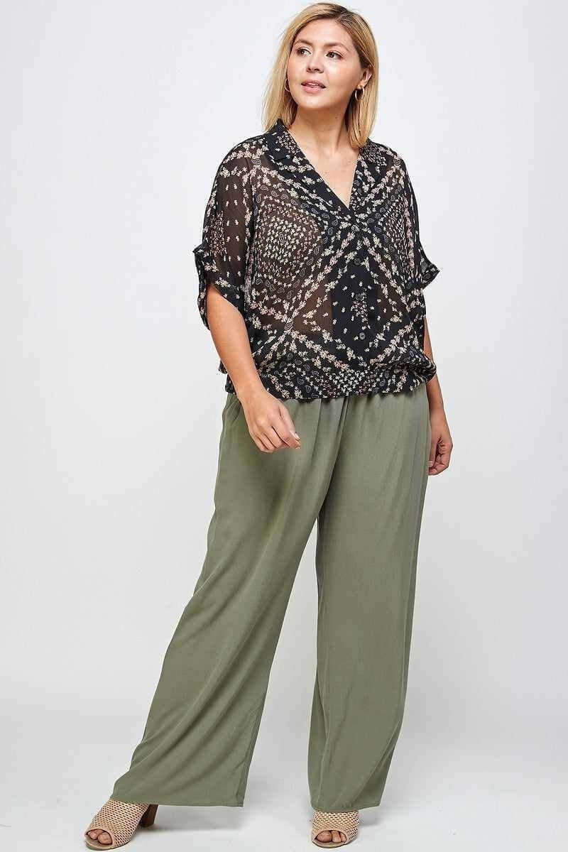 Plus size model in stylish green trousers and patterned top from Curvy Bottoms Collection