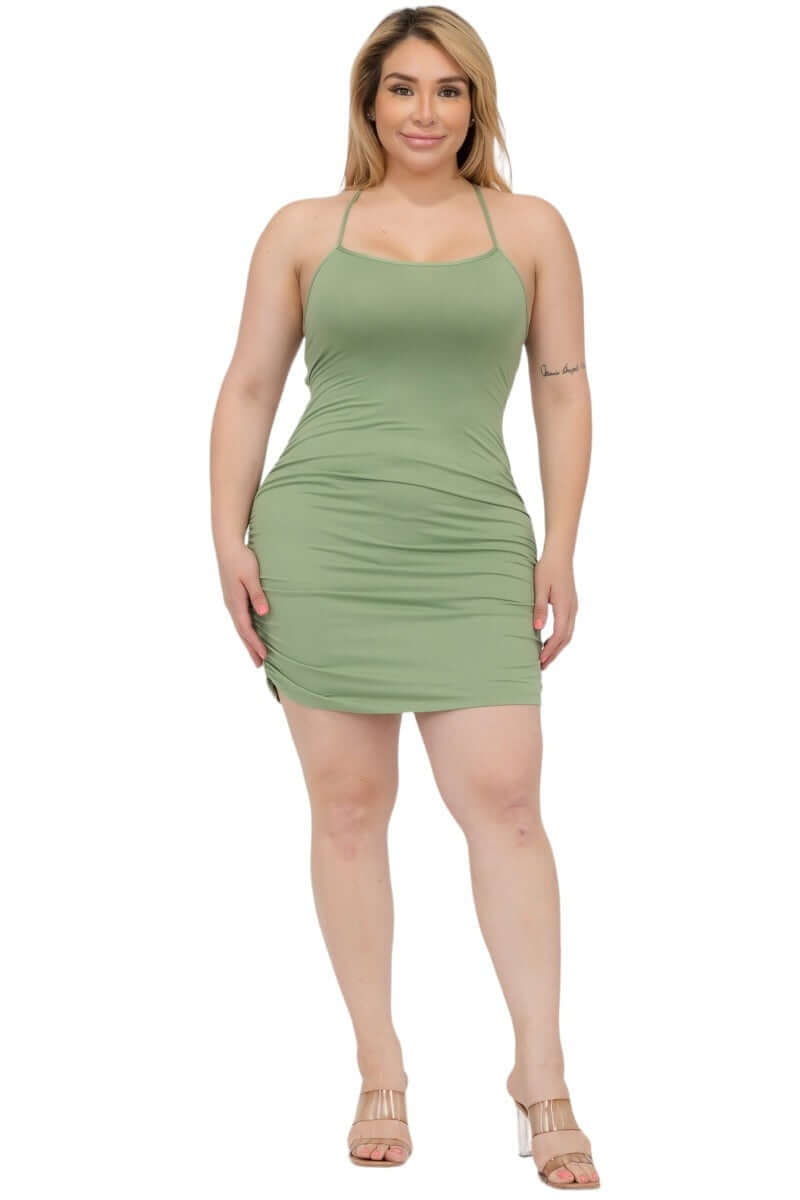 Plus size woman in a green curve-hugging bodycon dress for the Curvy Curve-Hugging Dresses collection.