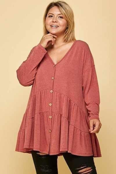 Plus-sized woman in a stylish pink long sleeve top with buttons, from our Curvy Long Sleeve Tops collection.