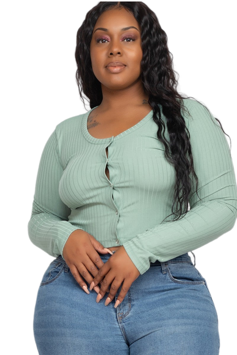 Plus size woman in green ribbed curvy crop top and jeans, showcasing stylish and flattering fashion for unique body shapes.