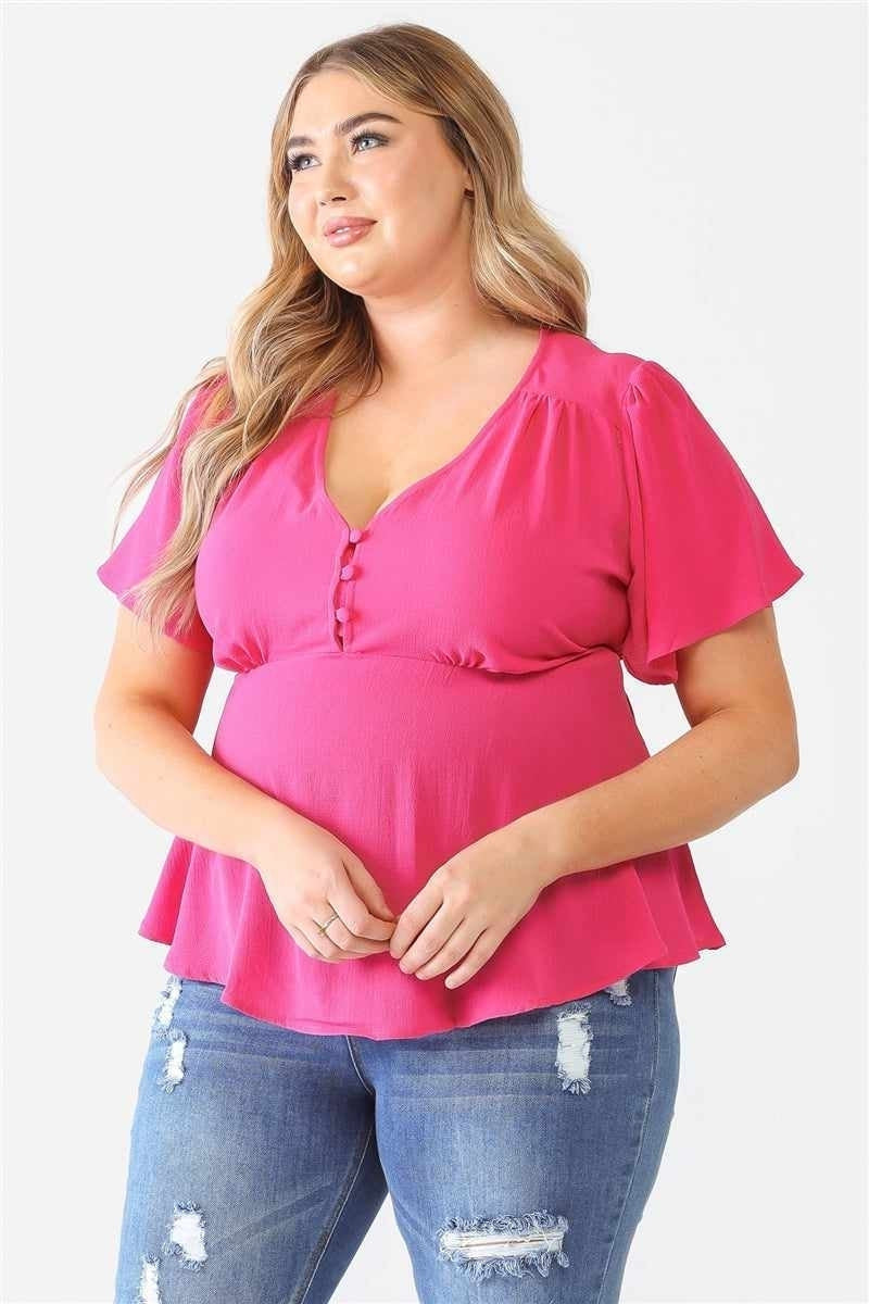 Pink plus size top for curvy women, embracing body positivity and style diversity.