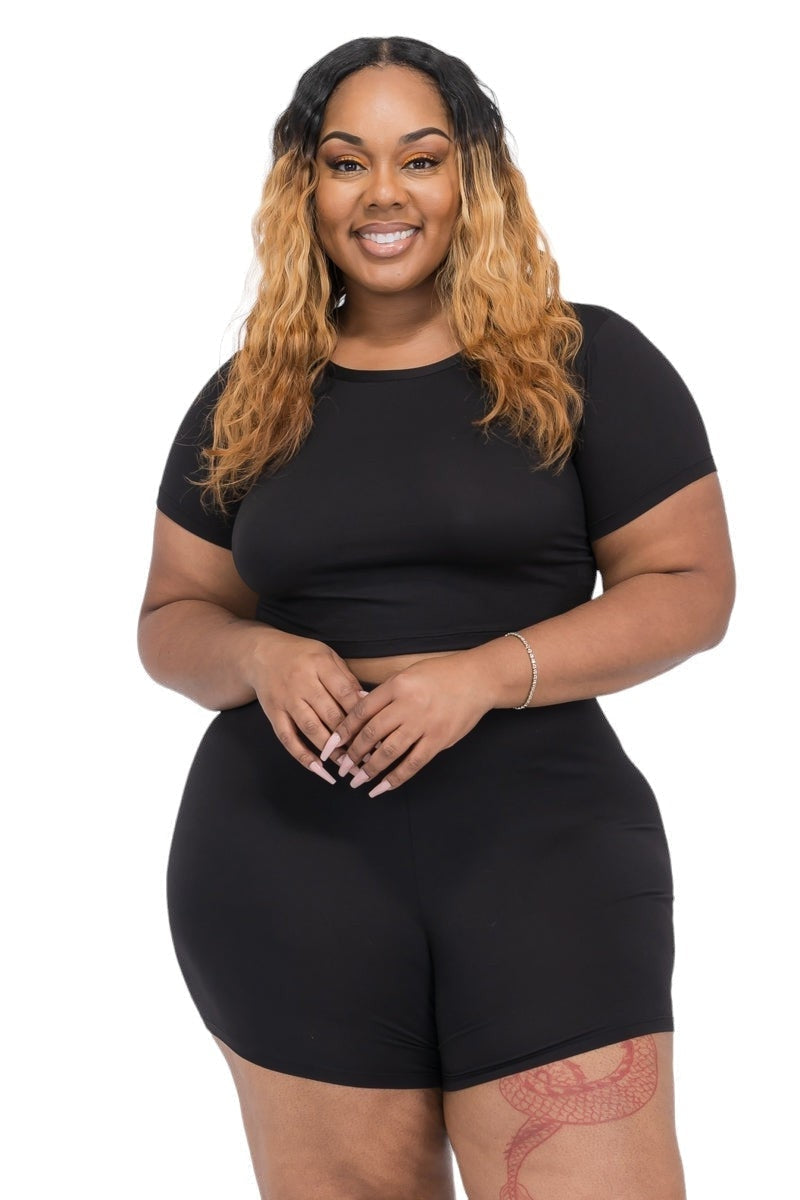 Plus size woman in black two-piece set, embodying confidence and style.