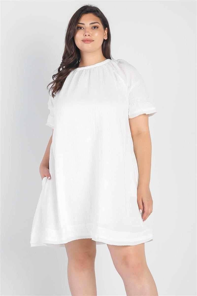 Plus size model wearing a stylish curvy white dress, showcasing effortless elegance and confidence for any special occasion.