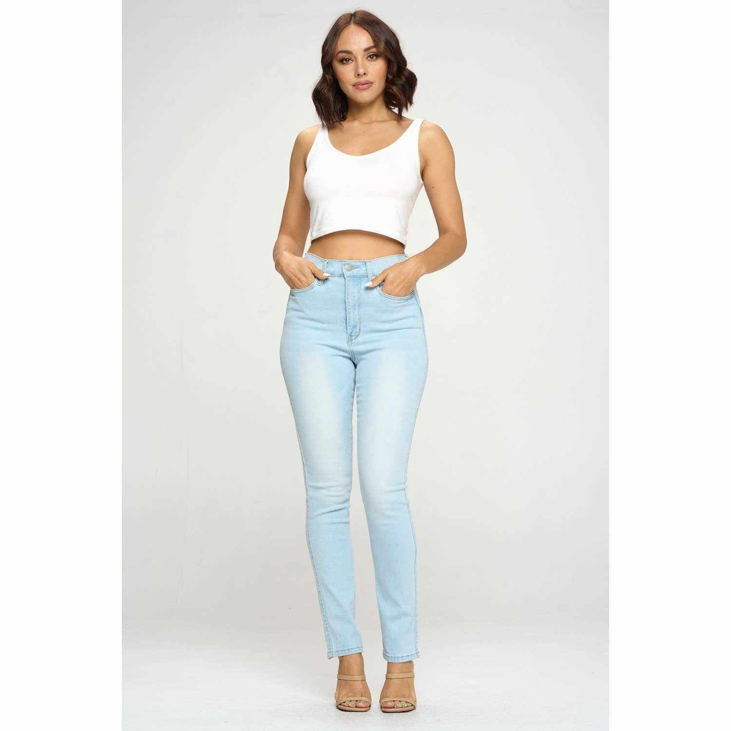 Woman wearing light blue high-waisted skinny jeans from the Denim Dreams collection, showcasing a stylish and versatile look.