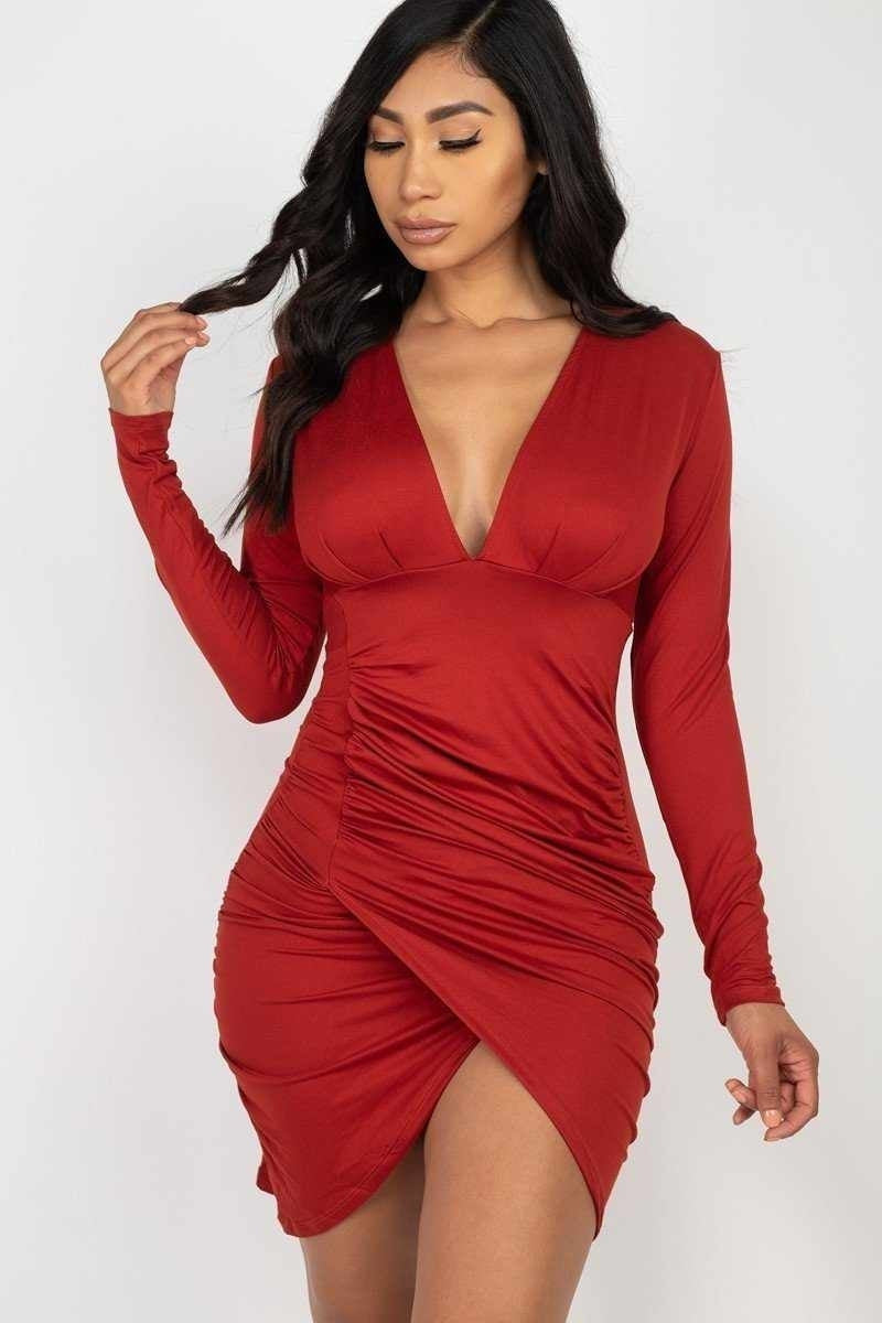 Woman in a red elegant dress with long sleeves and ruched detailing, perfect for cocktail parties.