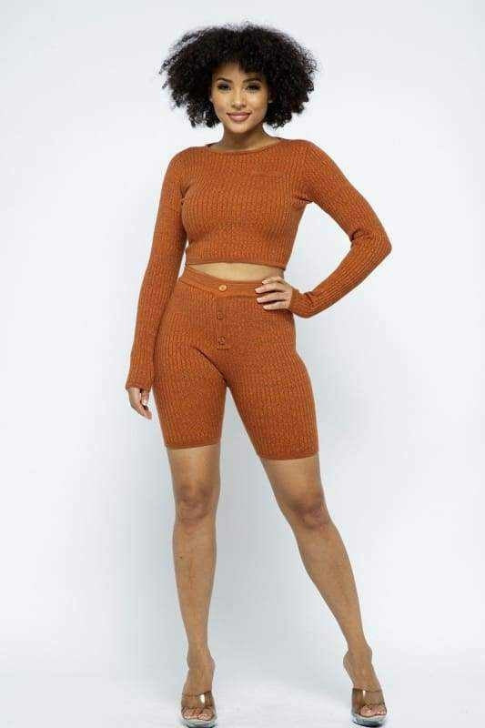 Woman wearing trendy rust-colored knit two-piece outfit from Latest Fashion Trends collection.