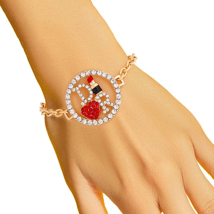 Elegant gold bracelet with red gemstone and diamond accents enhances sophisticated style. Perfect jewelry piece for any occasion.