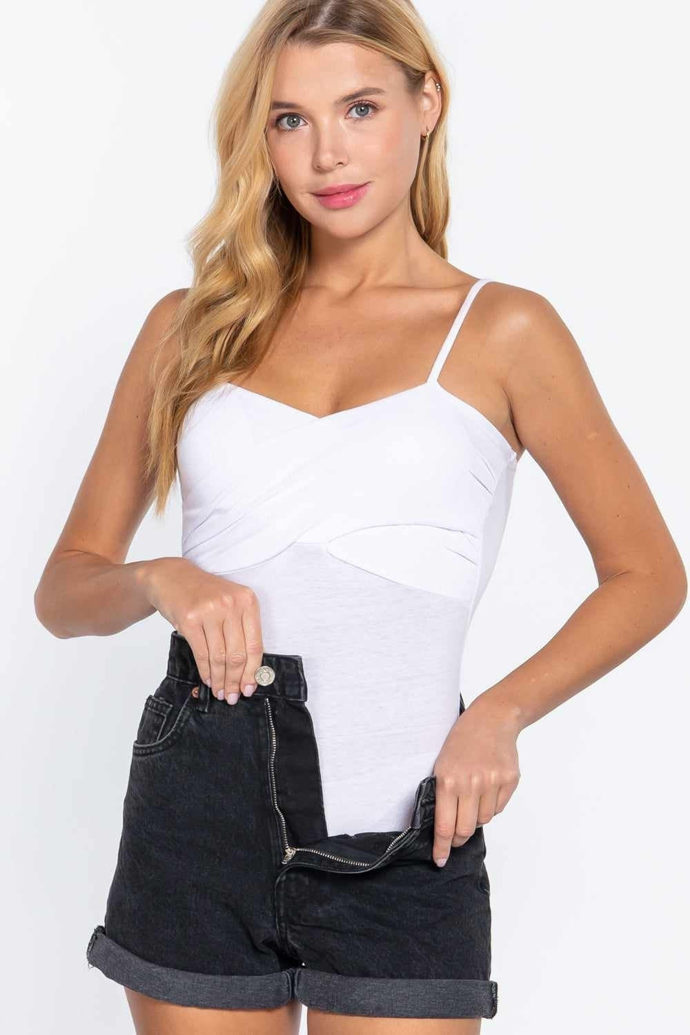 Trendy white women's bodysuit styled with black denim shorts, perfect for a casual and fashionable look.