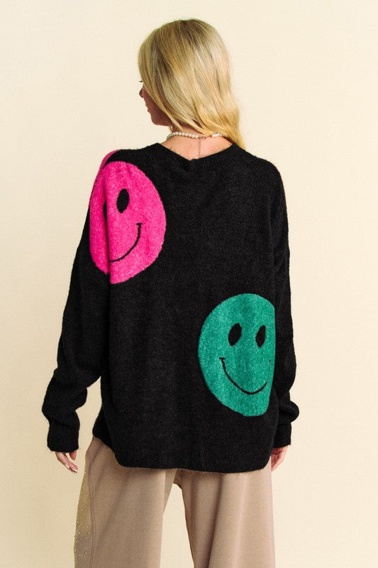 Black contrast smiley face oversize sweater with pink and green design, round neck, slightly stretchy material.