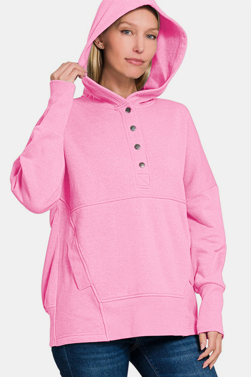 Pink half snap long sleeve hoodie with kangaroo pocket, featuring ribbed details and slightly stretchy cotton-polyester blend.