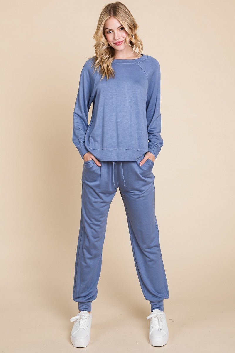 Powder blue lounge set with round neck raglan sleeve top and pants, slightly stretchy fabric, perfect for casual comfort.