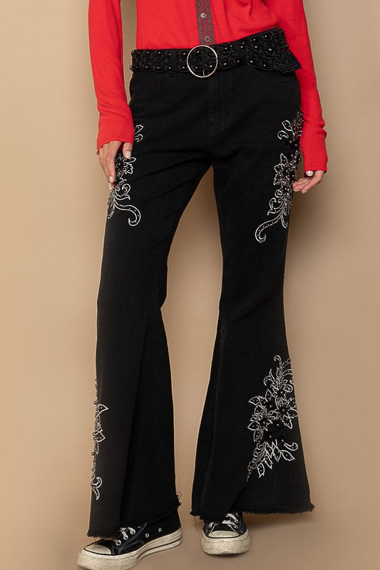 Black raw hem embroidered flare pants with pockets, featuring 95% cotton and 5% spandex for comfort and style.