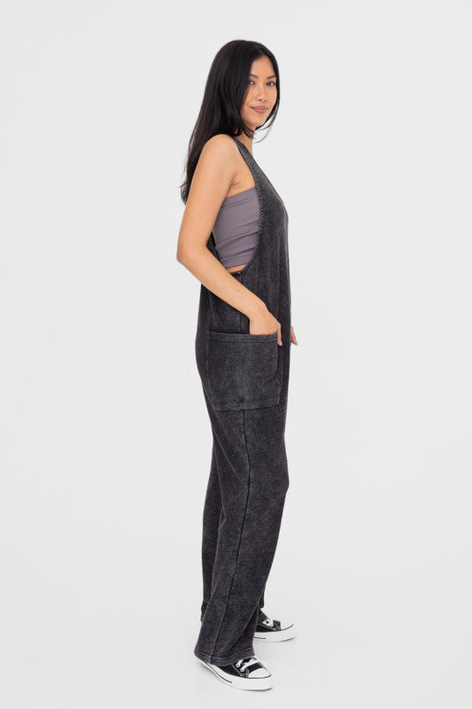 Black mineral-washed V neck overalls with pockets, made of 100% cotton, featuring a basic style and opaque finish.