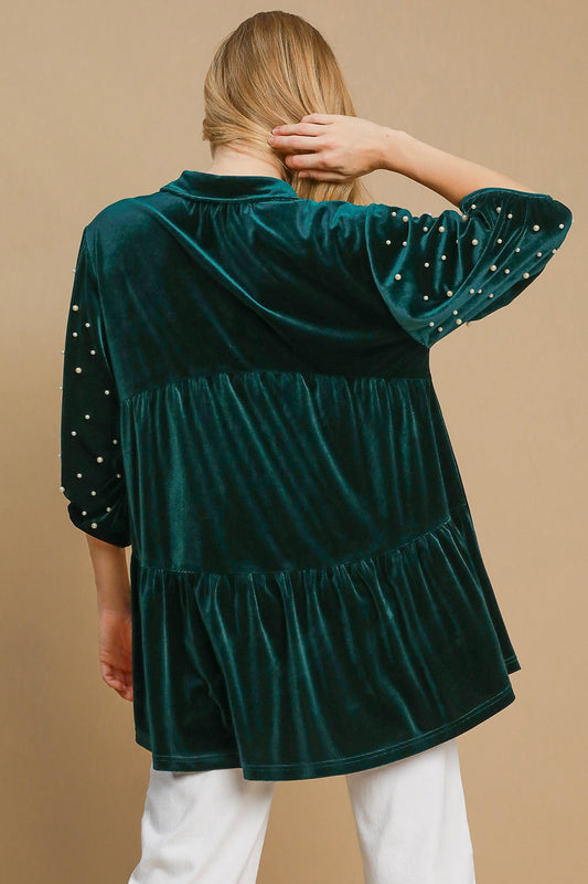 Hunter green velvet babydoll blouse with pearl detailing and half sleeves, buttoned and ruched design, tiered, slightly stretchy fabric.