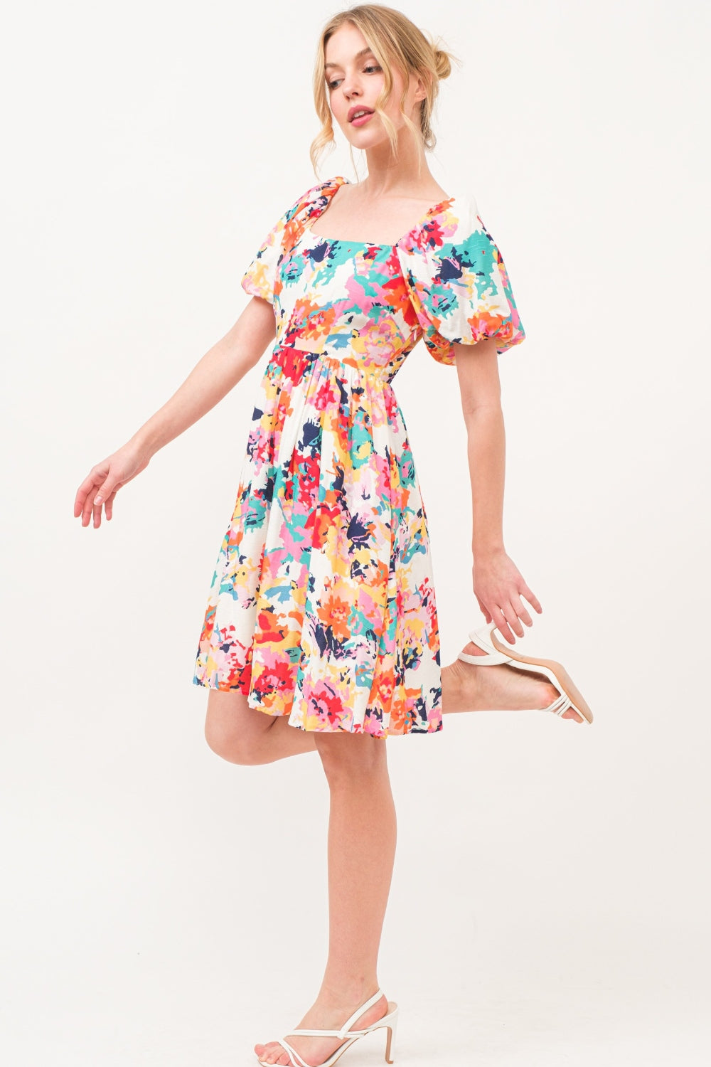 Multicolor floral dress with square neck and puff sleeves, featuring a ruched design and pockets, made from 100% polyester.