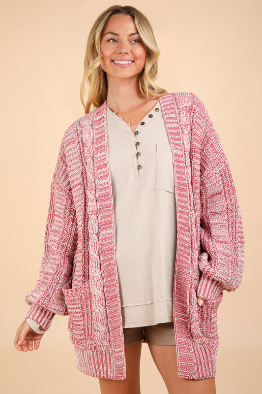 Woman wearing pink cable knit open front cardigan, perfect for spring, fall, and winter, featuring a classic tweed design and cozy fabric.