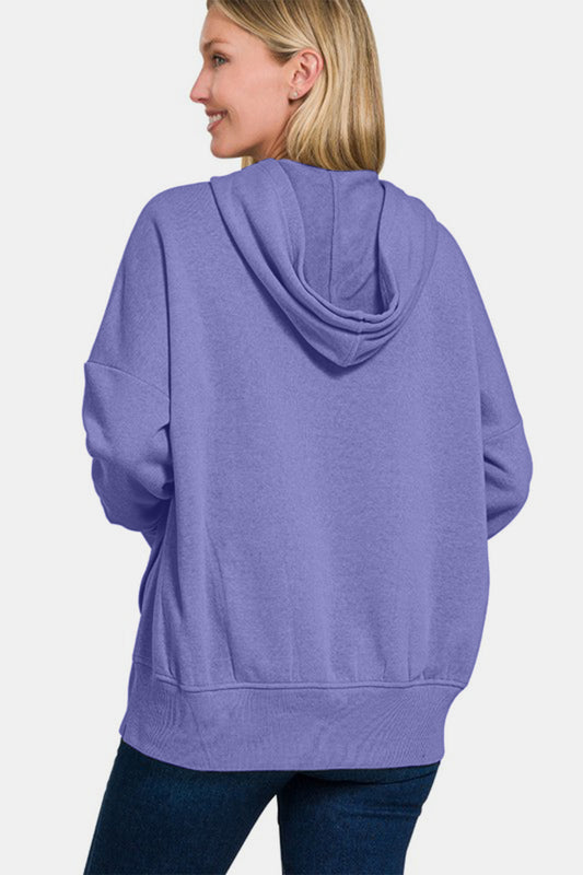 Woman wearing purple Zenana half snap long sleeve hoodie with kangaroo pocket, showcasing back view.