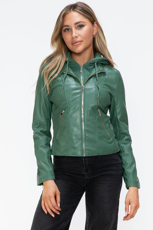 Woman wearing green faux leather zip-up drawstring hooded jacket with pockets.