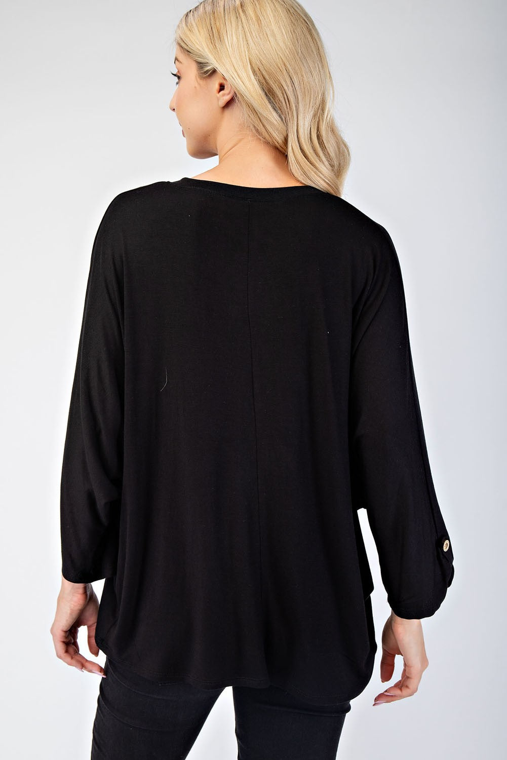 Woman wearing black full-size notched three-quarter sleeve blouse, made of 96% rayon and 4% spandex, showing rear view.