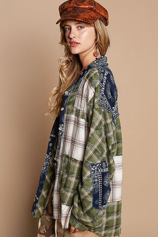 Woman wearing moss patchwork plaid button-up shirt with exposed seams and raw hem, 100% cotton, paired with orange cap.