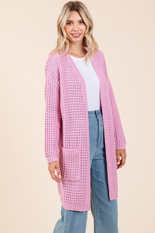 Pink waffle-knit open front cardigan with long sleeves, ribbed design, and pockets, made of 100% acrylic.