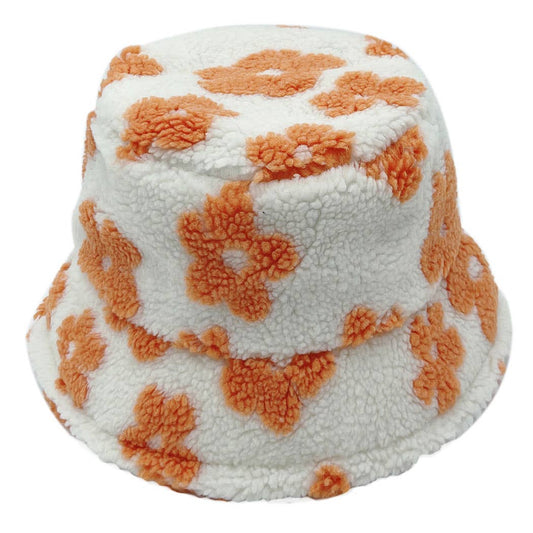 Winter Sherpa bucket hat with orange floral pattern, flat top, cozy design, adjustable strings, 100% polyester, size 22.25 inches.