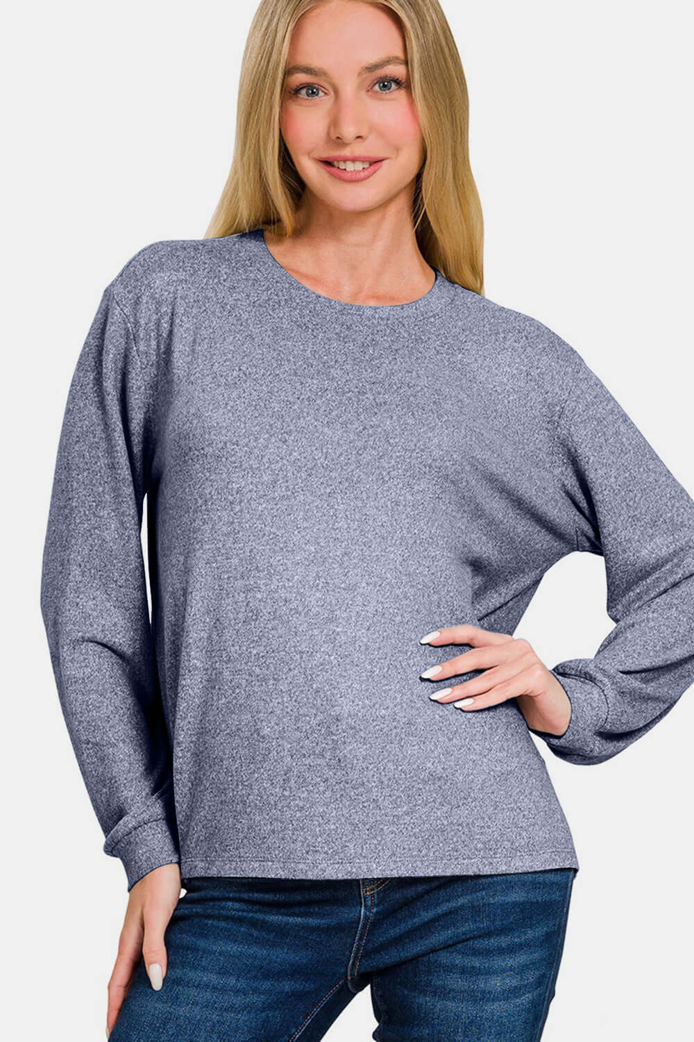 Woman wearing a light navy Hacci round neck long sleeve T-shirt with slightly stretchy fit, made of 95% polyester and 5% spandex.