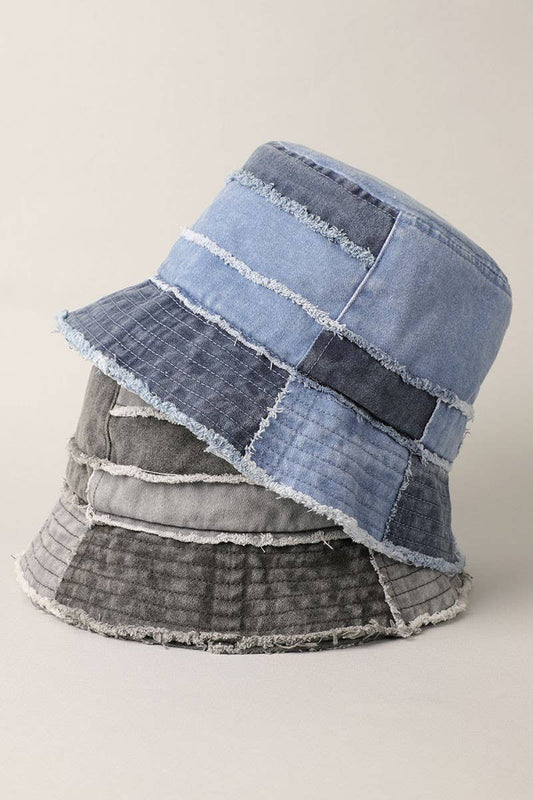 Frayed patchwork canvas denim bucket hats in multicolor with narrow brim, showcasing a worn-in feel and unique stitching design.