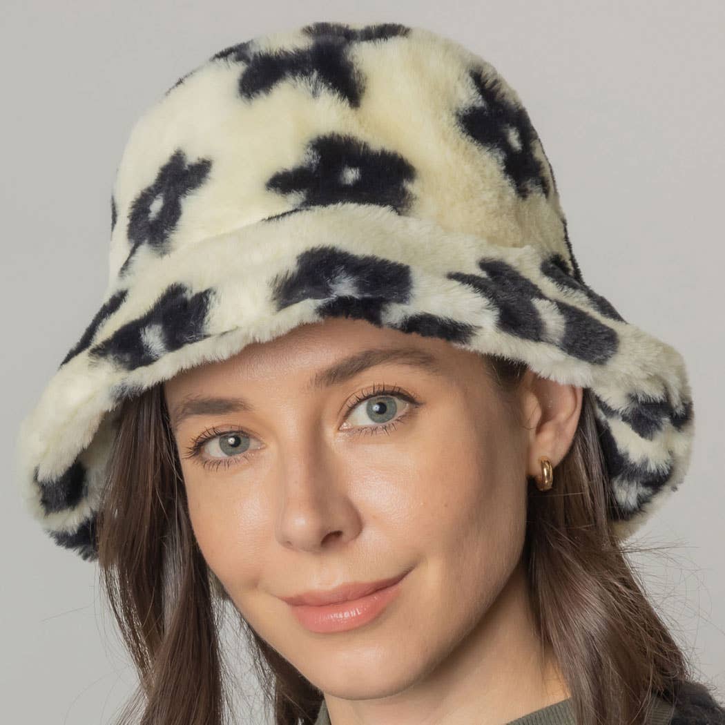 Woman wearing a floral printed faux fur bucket hat with adjustable strings, featuring a cozy flat top design for winter.