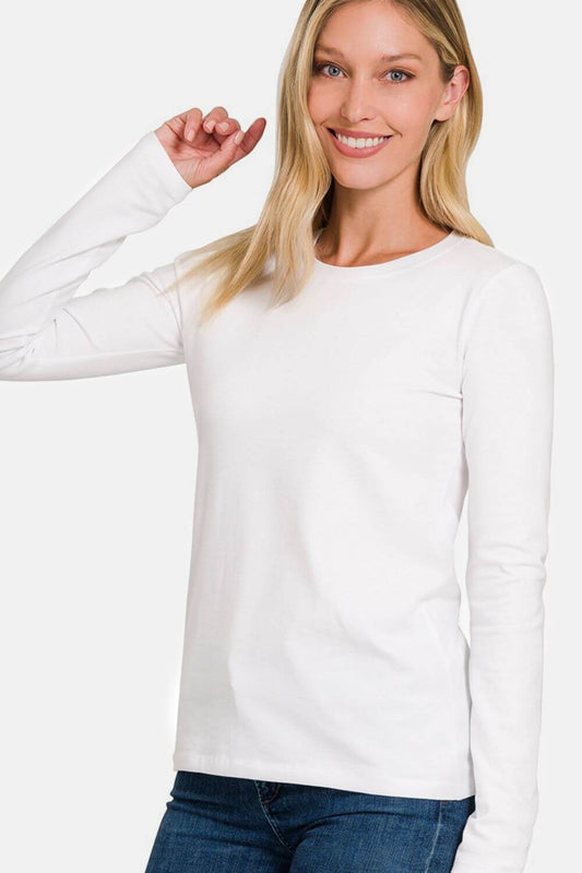 Woman wearing a white full size round neck long sleeve T-shirt made of 95% cotton and 5% spandex.