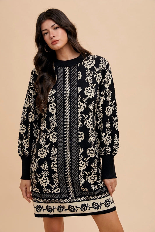 Woman wearing Faith Floral Jacquard Round Neck Sweater Dress, featuring elegant black and white floral design, perfect for fall fashion.