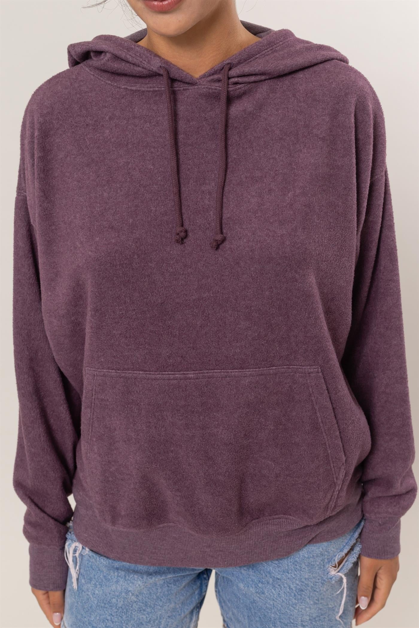 Dark plum brushed long sleeve hoodie with kangaroo pocket, featuring drawstrings, slightly stretchy material, worn by a model.