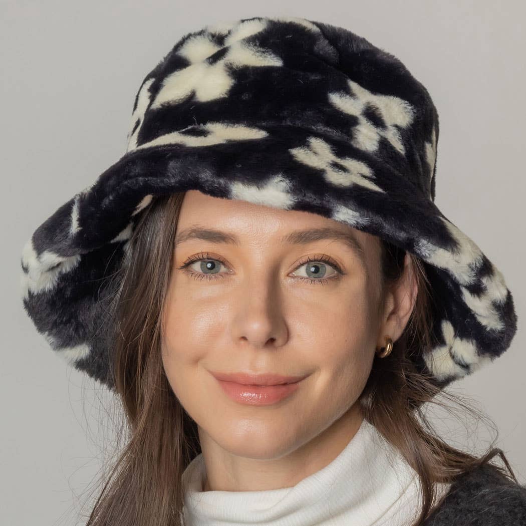 Woman wearing a floral printed faux fur bucket hat with adjustable strings and cozy design for winter.