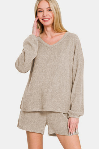 Woman wearing Zenana V-Neck Long Sleeve Ribbed Top and Shorts Set in beige, showcasing casual chic style with comfort.