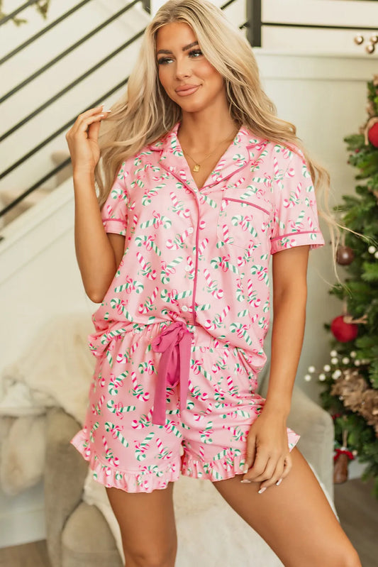 Woman wearing Candy Cane Collared Neck Top and Shorts Pajama Set with festive design in a home setting.