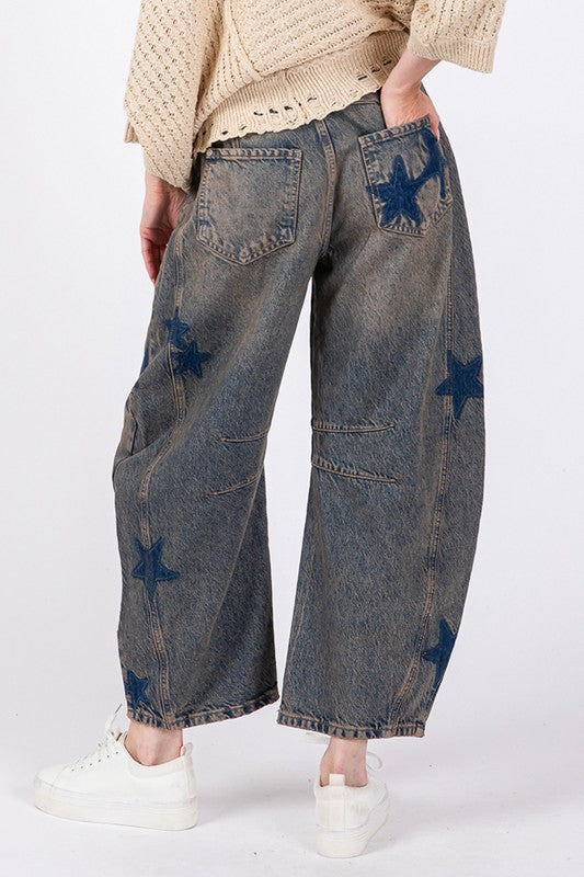 Woman wearing Star Wide Leg Jeans with Pockets, featuring star patterns and slightly stretchy 100% cotton denim, paired with white sneakers.