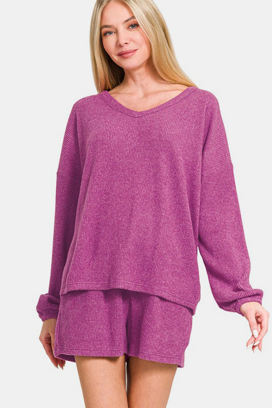 Woman wearing Zenana V-Neck Long Sleeve Ribbed Top and Shorts Set in purple, showcasing a stylish and comfortable casual outfit.