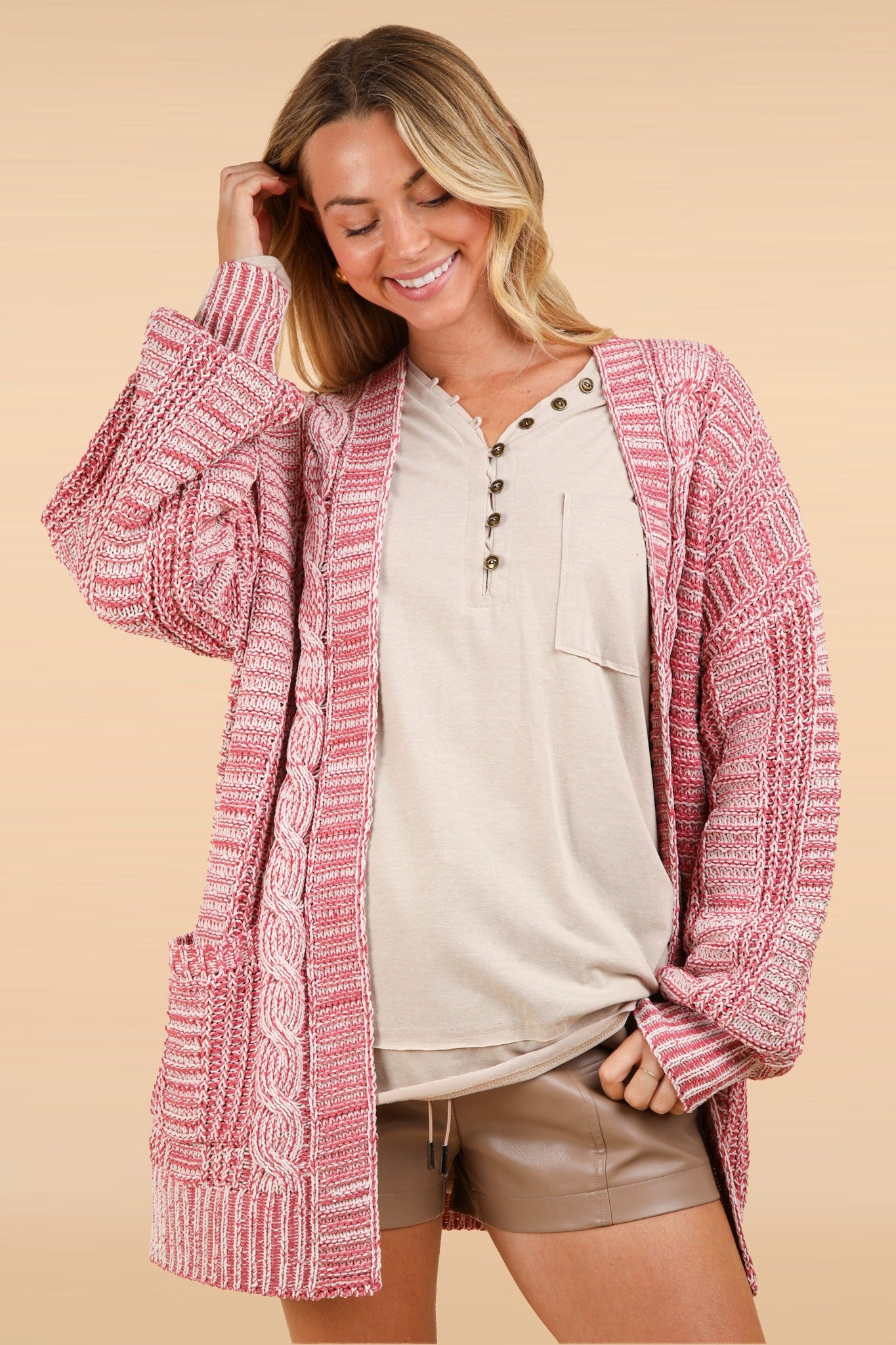 Woman wearing a pink VERY J cable knit open front cardigan with tweed design, ideal for spring and fall fashion.