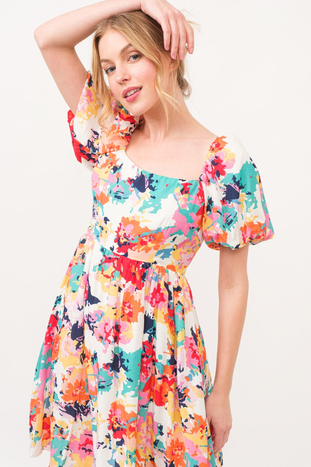 Multicolor square neck puff sleeve floral dress, ruched with pockets, made of 100% polyester, showcasing vibrant floral design.