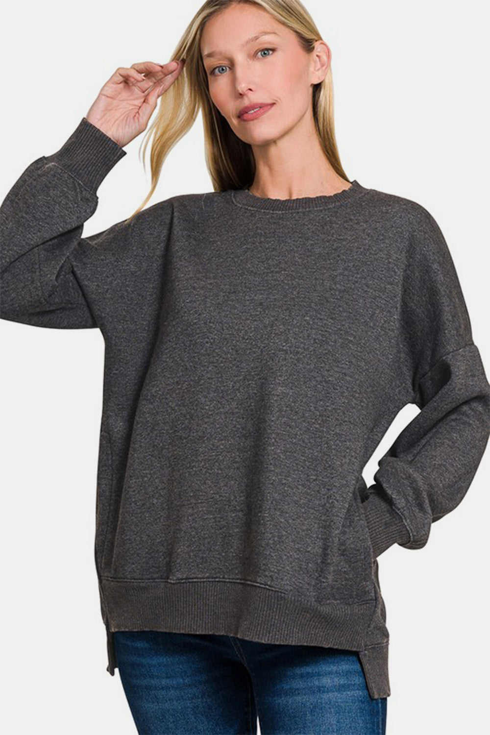 Woman wearing Zenana high-low acid wash fleece sweatshirt in charcoal gray.