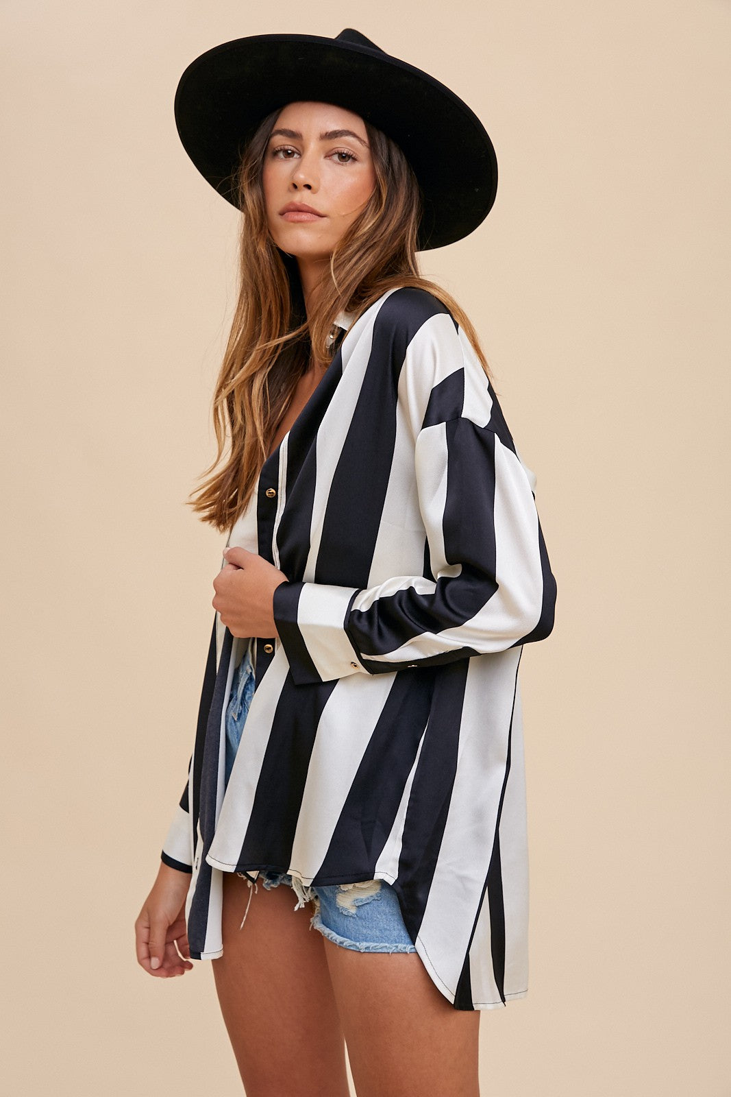 Woman wearing a Fall Striped Dropped Shoulder Button Up Shirt with black hat, showcasing casual fashion style.