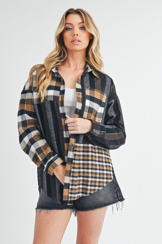 Woman wearing a black curved hem plaid button-up shirt made from 100% cotton, styled with dark denim shorts.